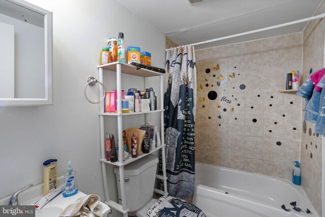 bathroom featuring shower / bath combo and toilet