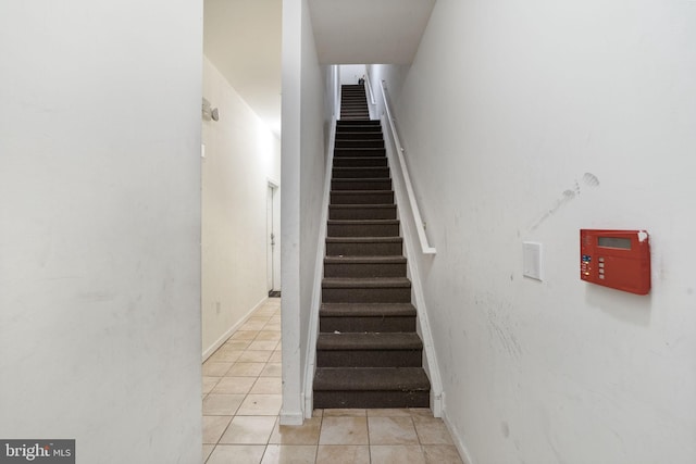 staircase featuring tile patterned floors