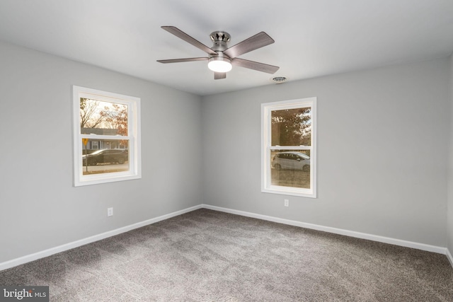 carpeted empty room featuring ceiling fan