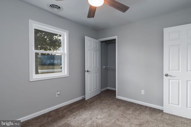 unfurnished bedroom with carpet floors, a closet, and ceiling fan