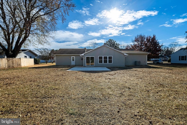 back of house with a yard and a patio