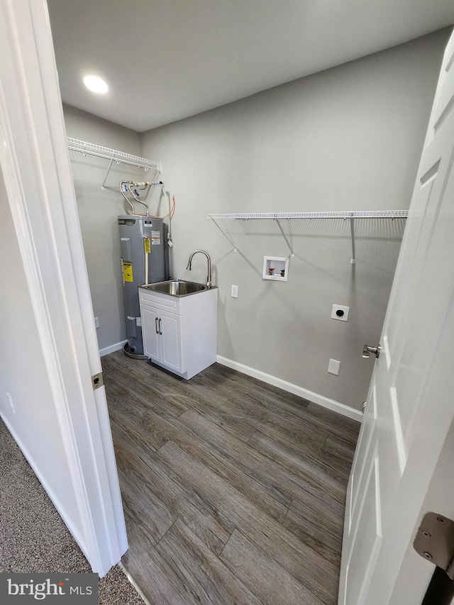 laundry room with washer hookup, dark hardwood / wood-style flooring, electric dryer hookup, water heater, and sink