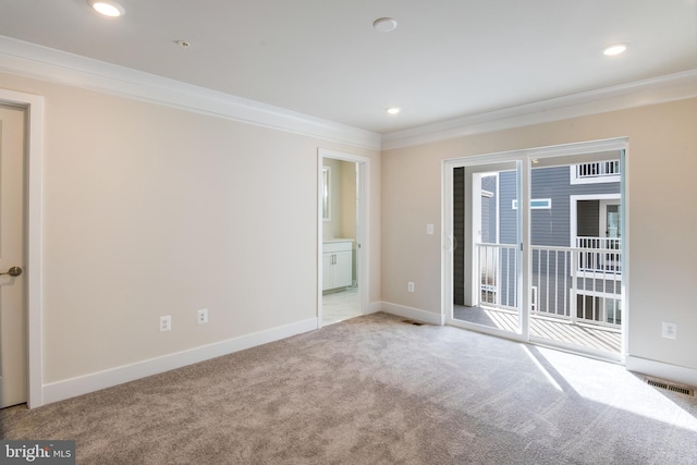 spare room with light colored carpet and crown molding