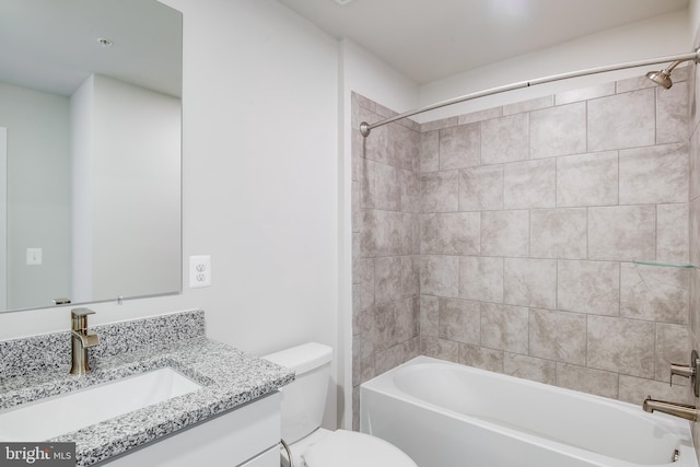 full bathroom featuring vanity, toilet, and tiled shower / bath