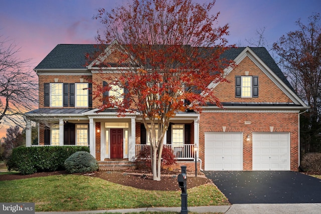 view of front of home with a porch and a garage