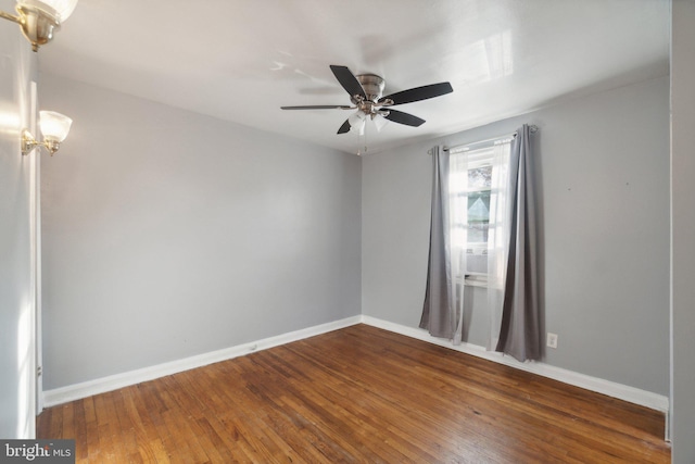 unfurnished room with ceiling fan and dark wood-type flooring