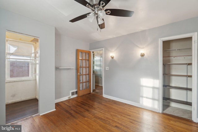 interior space with ceiling fan and dark wood-type flooring