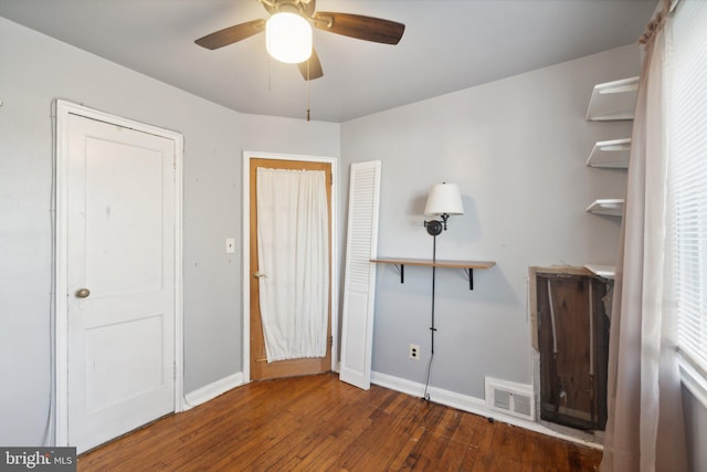 unfurnished bedroom featuring dark hardwood / wood-style floors and ceiling fan