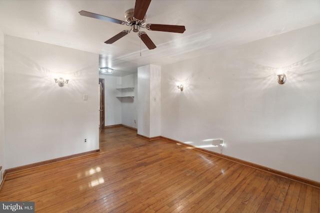 unfurnished room with ceiling fan and hardwood / wood-style flooring