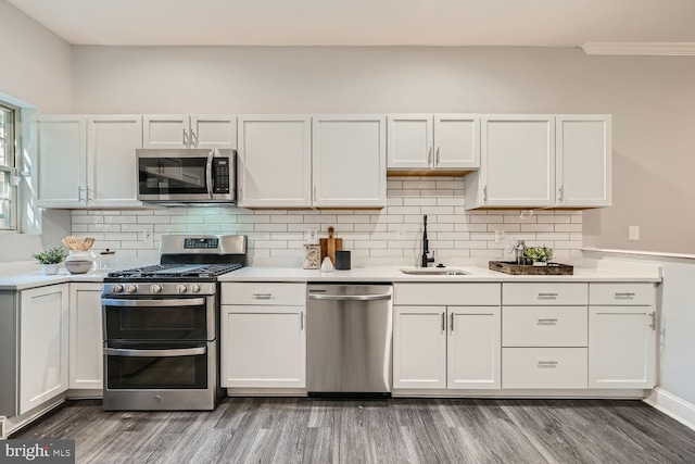 kitchen with white cabinetry, dark hardwood / wood-style flooring, stainless steel appliances, and sink