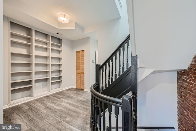 stairs featuring hardwood / wood-style floors