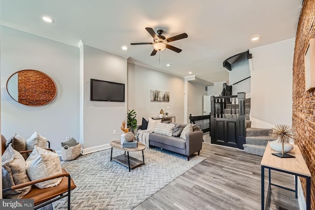 living room with ceiling fan, light hardwood / wood-style flooring, and ornamental molding