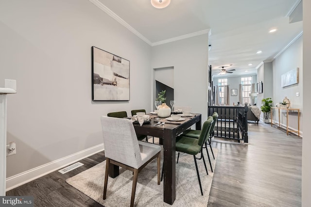 dining room featuring crown molding, hardwood / wood-style floors, and ceiling fan