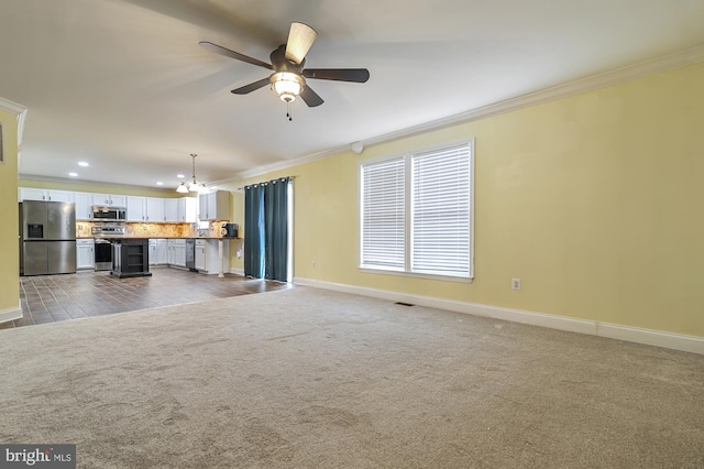 unfurnished living room featuring hardwood / wood-style floors, ceiling fan with notable chandelier, and ornamental molding