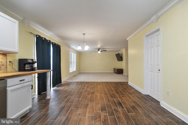 unfurnished living room featuring crown molding, dark hardwood / wood-style flooring, and ceiling fan with notable chandelier