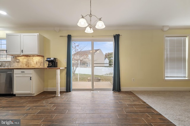 unfurnished dining area featuring a notable chandelier, crown molding, and dark wood-type flooring