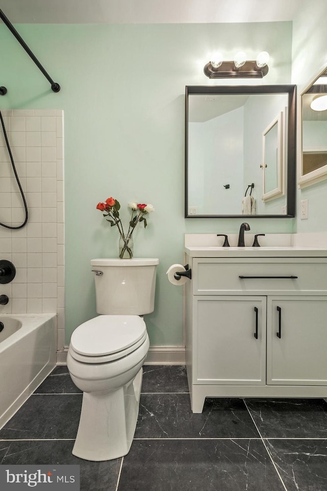 full bathroom featuring vanity, toilet, and tiled shower / bath