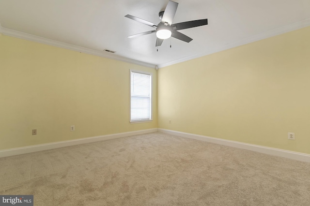 carpeted empty room with ceiling fan and ornamental molding