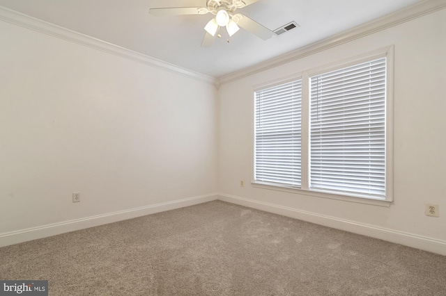 spare room with carpet floors, ceiling fan, and ornamental molding