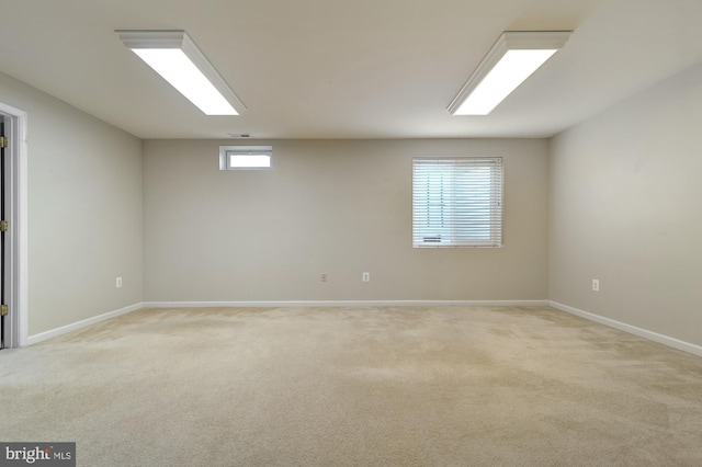 unfurnished room with a wealth of natural light and light colored carpet