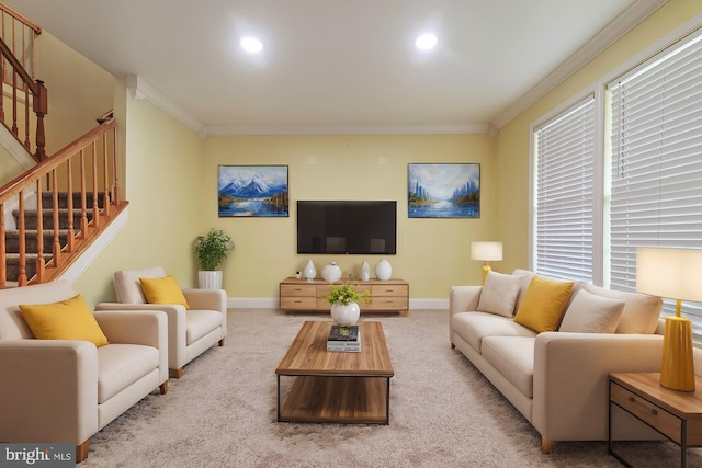 carpeted living room with a healthy amount of sunlight and crown molding