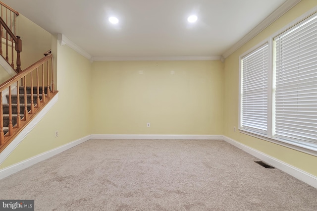 empty room featuring carpet flooring and ornamental molding