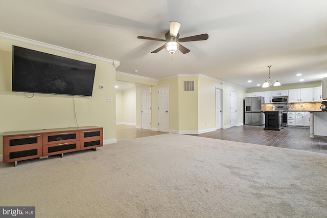 unfurnished living room with crown molding, dark hardwood / wood-style flooring, and ceiling fan with notable chandelier