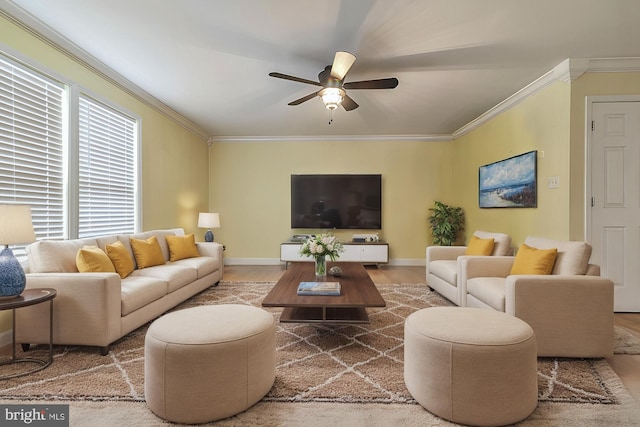 living room with hardwood / wood-style floors, ceiling fan, and ornamental molding