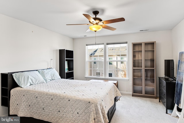 bedroom featuring light carpet, ceiling fan, visible vents, and baseboards