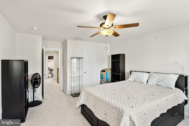 bedroom featuring a ceiling fan, light colored carpet, and baseboards