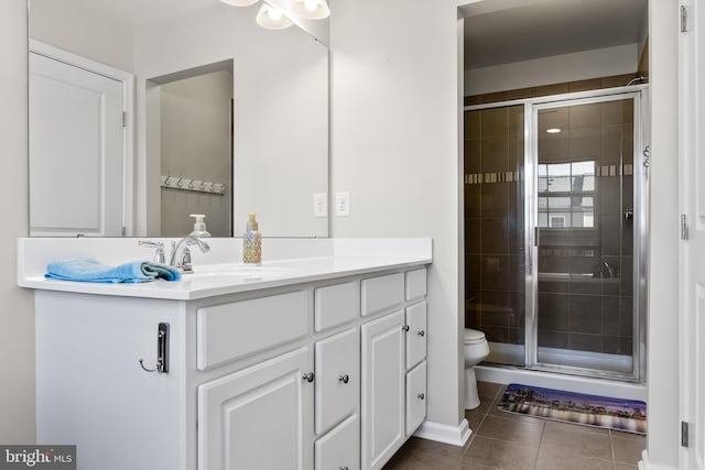 full bathroom featuring toilet, a stall shower, tile patterned flooring, and vanity