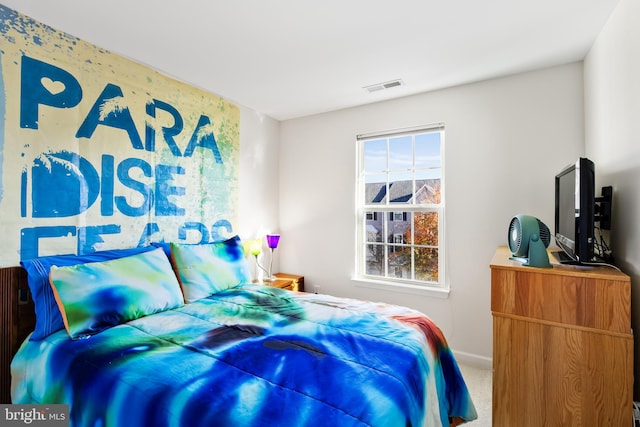 carpeted bedroom with visible vents and baseboards