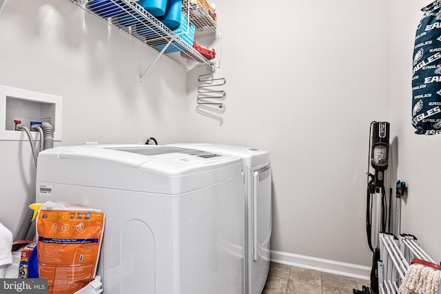 laundry room with laundry area, washing machine and dryer, and baseboards