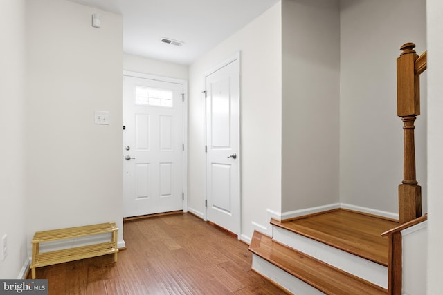 entrance foyer with light wood-style floors, visible vents, and baseboards