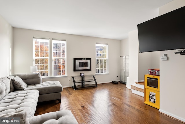 living area featuring wood finished floors and baseboards