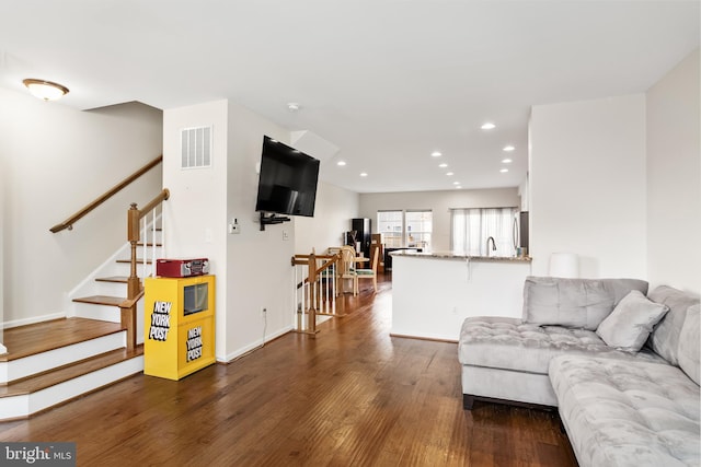 living area with baseboards, visible vents, dark wood finished floors, stairway, and recessed lighting