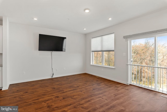 unfurnished living room featuring dark hardwood / wood-style floors