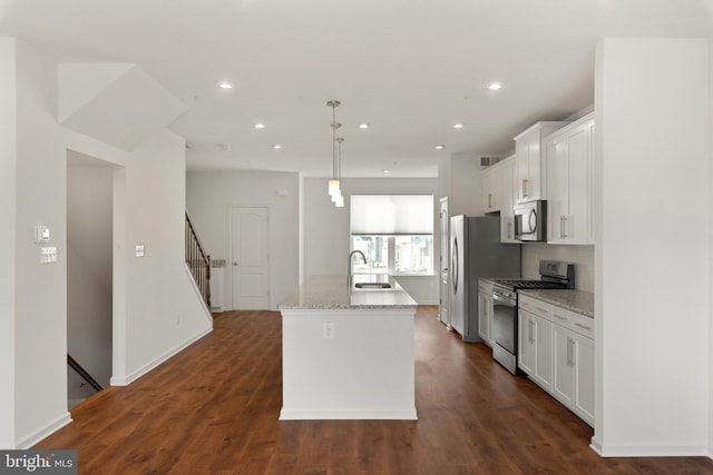 kitchen with sink, dark hardwood / wood-style flooring, decorative light fixtures, white cabinets, and appliances with stainless steel finishes