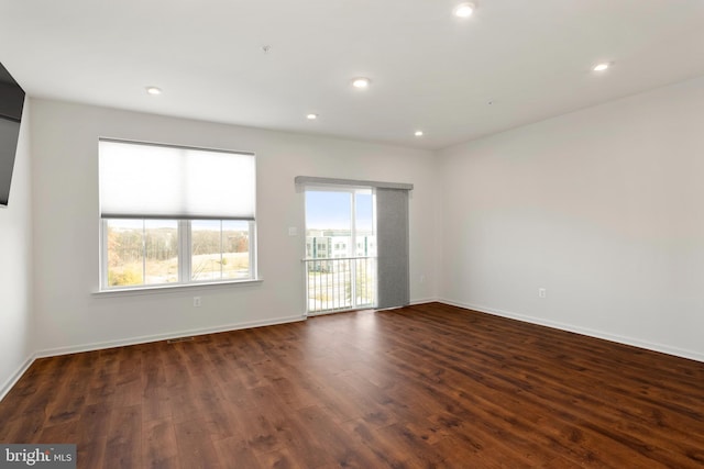 empty room with dark hardwood / wood-style flooring