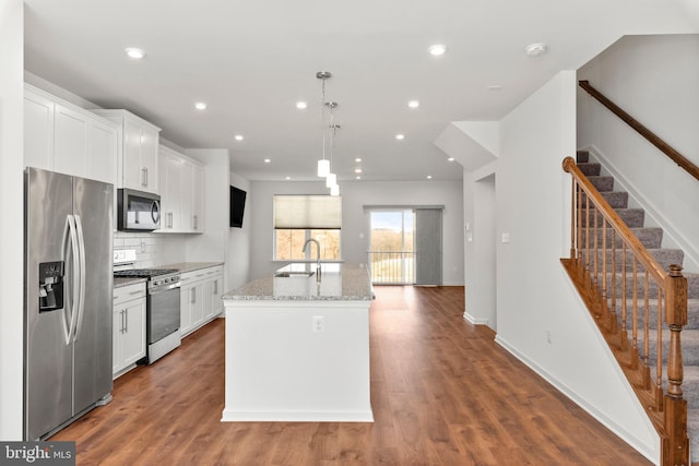 kitchen featuring white cabinetry, hardwood / wood-style floors, and stainless steel appliances