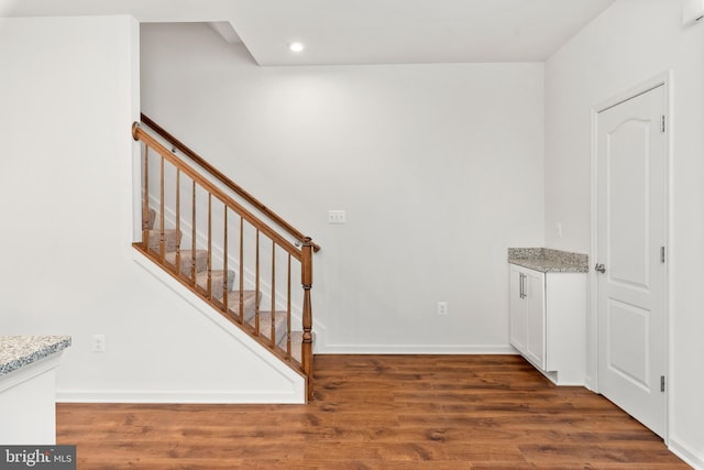 stairs with hardwood / wood-style flooring