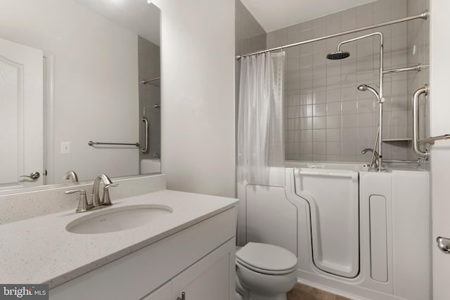 full bathroom featuring shower / bath combo, vanity, and toilet