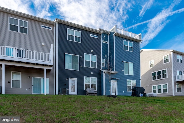 rear view of property with a lawn