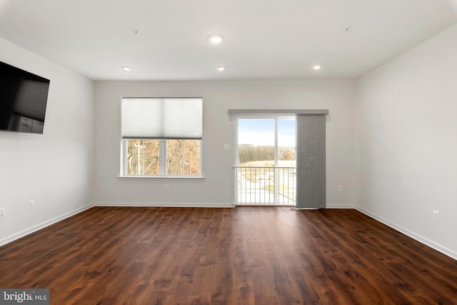 empty room with dark hardwood / wood-style flooring