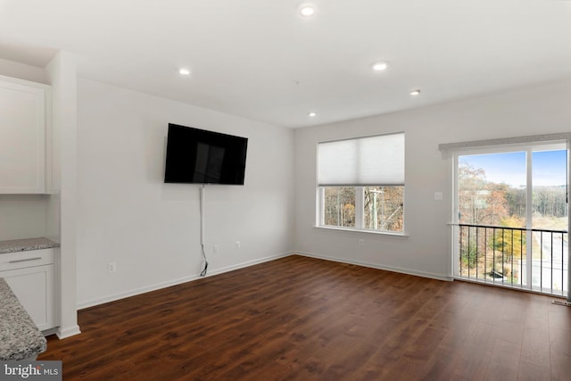 unfurnished living room with dark hardwood / wood-style floors