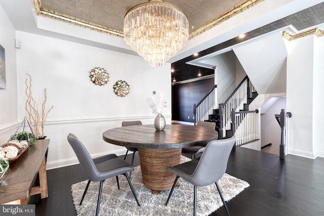 dining space with dark hardwood / wood-style flooring and a chandelier