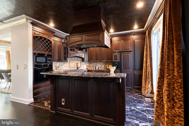 kitchen featuring dark brown cabinetry, crown molding, black appliances, and dark stone counters