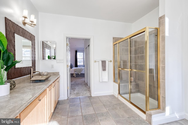 bathroom with vanity and a shower with door