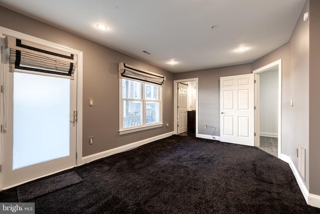 interior space with dark colored carpet