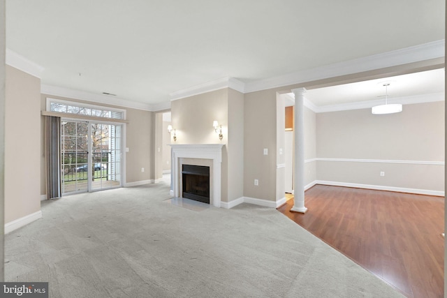 unfurnished living room featuring light hardwood / wood-style floors, ornamental molding, and ornate columns